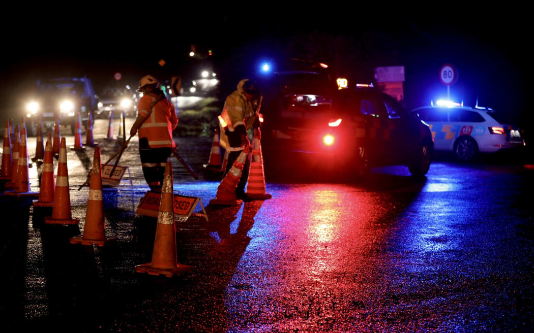 Police cars parked across the road at the scene of a triple fatality in Waiuku, in July 2025.