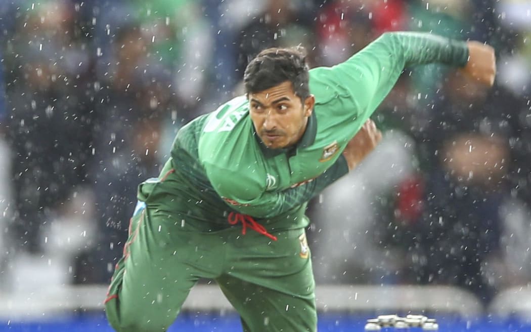 Soumya Sarkar of Bangladesh bowling in the rain