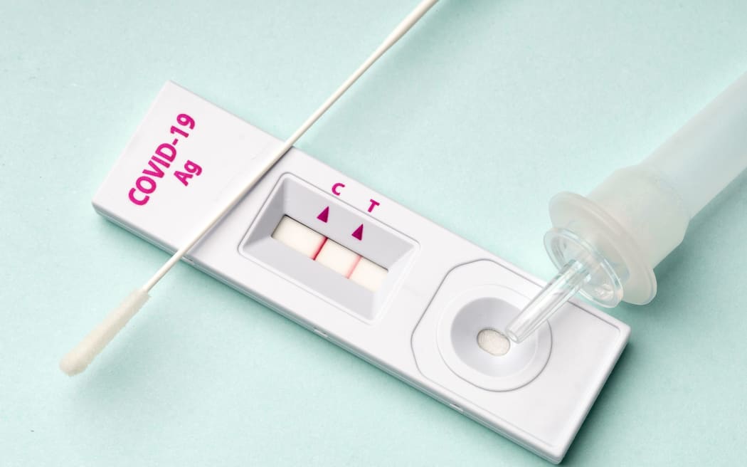 Rapid test device for COVID-19 virus with a positive result.