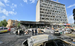 Firefighters inspect a damaged building following a Russian airstrike in the city of Vinnytsia, west-central Ukraine on July 14, 2022.