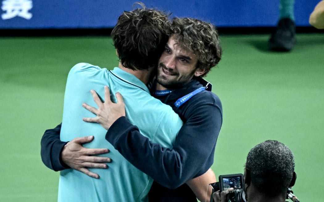 France’s Arthur Rinderknech (L) hugs his cousin, Monaco’s Valentin Vacherot after both qualified for the Shanghai Masters tennis final.