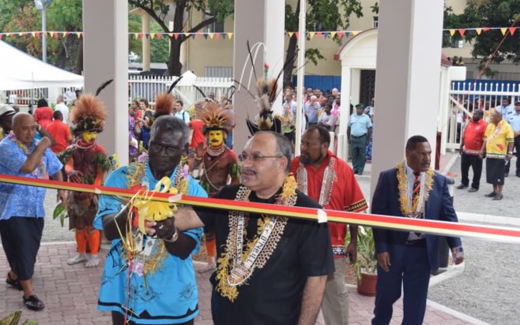 Solomon Islands Prime Minister Manasseh Sogavare and Peter O'Neill cut the ribbon to open the PNG Chancery