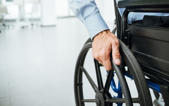 close-up of hand and wheelchair