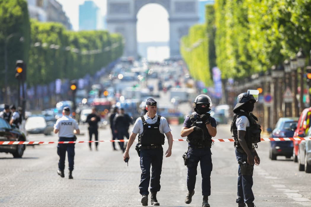 Police patrol the Champs-Elysees after a car crashed into a police van before bursting into flames.