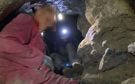 Men in the 'secret' cave - Waikaretu Valley