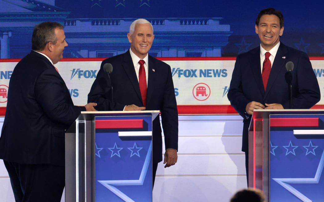 MILWAUKEE, WISCONSIN - AUGUST 23: Republican presidential candidates (L-R), former New Jersey Gov. Chris Christie, former U.S. Vice President Mike Pence and Florida Gov. Ron DeSantis speak during a break in the first debate of the GOP primary season hosted by FOX News at the Fiserv Forum on August 23, 2023 in Milwaukee, Wisconsin. Eight presidential hopefuls squared off in the first Republican debate as former U.S. President Donald Trump, currently facing indictments in four locations, declined to participate in the event.   Win McNamee/Getty Images/AFP (Photo by WIN MCNAMEE / GETTY IMAGES NORTH AMERICA / Getty Images via AFP)