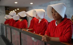 Protesters dressed in The Handmaid's Tale costume, protest outside the hearing room where Supreme Court nominee Judge Brett Kavanaugh will testify before the Senate Judiciary Committee during his Supreme Court confirmation hearing.