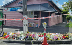 Flowers are seen outside Rose Cottage Superette in Sandringham, Auckland, after the fatal stabbing of a dairy worker on Wednesday, 23 November, 2022.