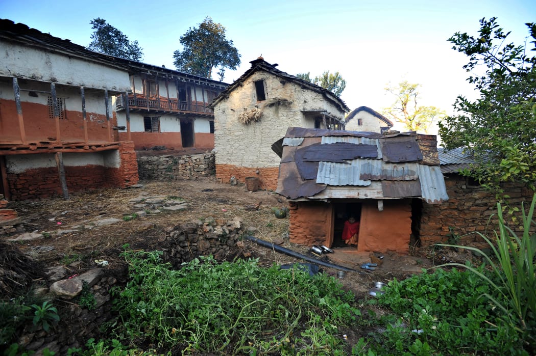 (FILES) In this file photo taken on November 23, 2011 a Nepali teenage girl sits inside a "chhaupadi house" in Achham village, some 800km west of Kathmandu.
