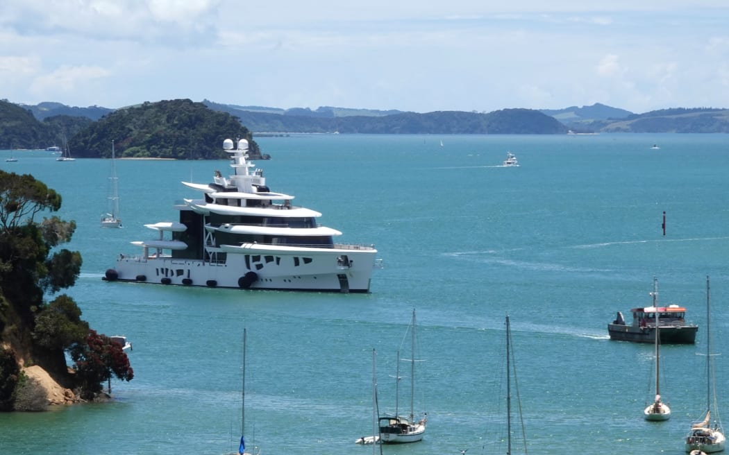 The 80-metre superyacht Artefact is escorted to Ōpua wharf by the harbourmaster's vessel Waikare.