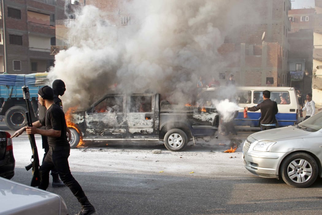 A police car on fire in Cairo.