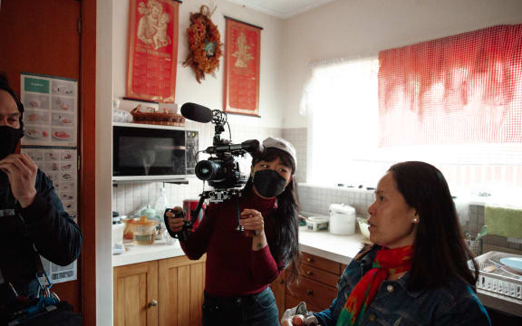 (L-R) Tane, Julie, and Hương in the kitchen