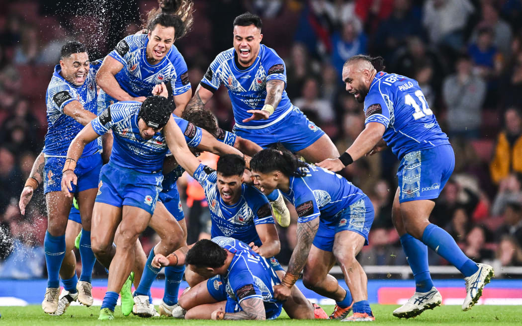Samoa celebrate winning their Rugby League World Cup semi-final over England.