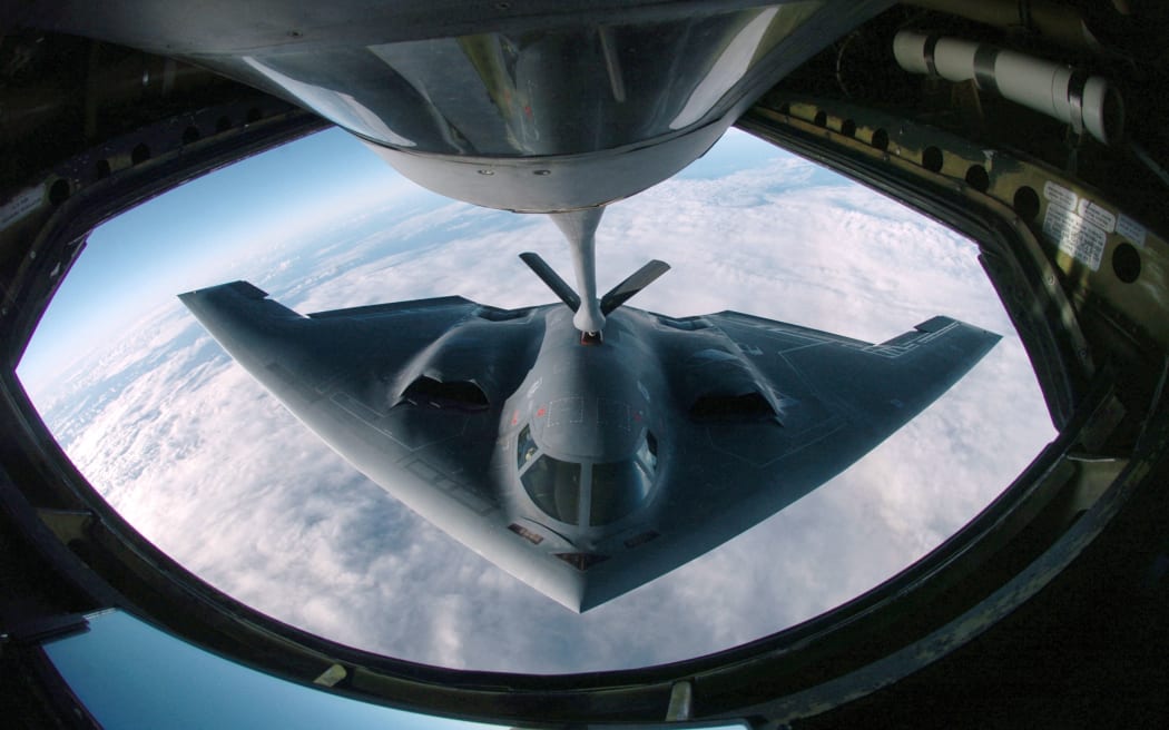 (FILES) This 4 April, 2005 Department of Defense handout image shows a B-2 Spirit multi-role bomber conducting air refueling operations with a KC-135 Stratotanker over the Pacific Ocean. US stealth bombers were flying on June 21, 2025 across the Pacific Ocean, according to tracking data and media reports, fueling speculation over their intended mission as President Donald Trump considers joining Israel's attack on Iranian nuclear sites. Multiple B-2 bomber aircraft left a base in the central United States overnight and were later tracked flying off the California coast along with aerial refueling jets, The New York Times and specialist plane tracking sites reported. (Photo by US Department of Defense / AFP) / RESTRICTED TO EDITORIAL USE - MANDATORY CREDIT "AFP PHOTO /  US DEPARTMENT OF DEFENSE"- NO MARKETING NO ADVERTISING CAMPAIGNS - DISTRIBUTED AS A SERVICE TO CLIENTS