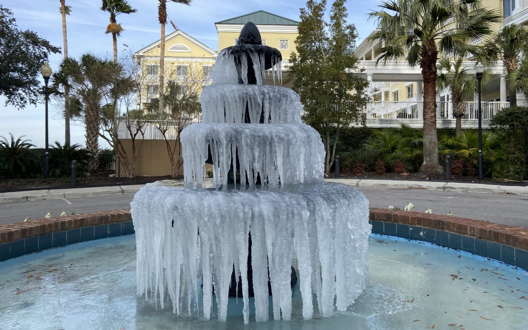 Ice adorns a fountain in Charleston, South Carolina, on December 24, 2022, where temperatures are forecast to reach a high of 32F (0C).