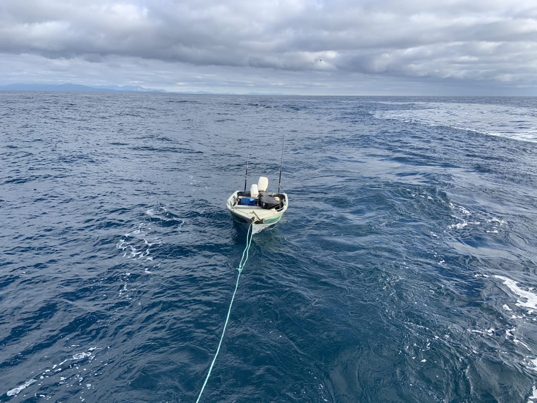 The dingy which made the trip across Cook Strait is towed to safety.