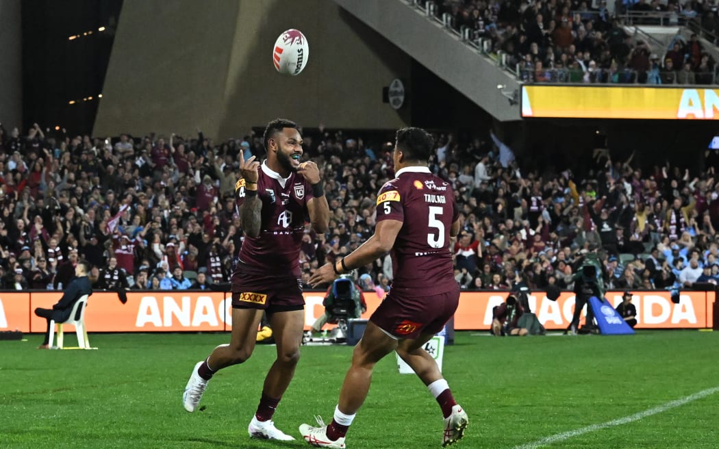 Hamiso Tabuai-Fidow of the Maroons celebrates his try with Murray Taulagi.