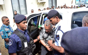 Police officers escort the murder suspect Muhammed Raheesh Isoof to the remand centre from Nadi Magistrates Court on September 18.