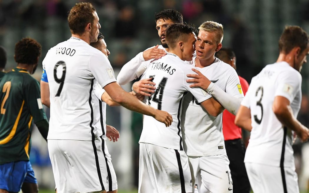 All Whites player Ryan Thomas celebrates his goal with team mates.