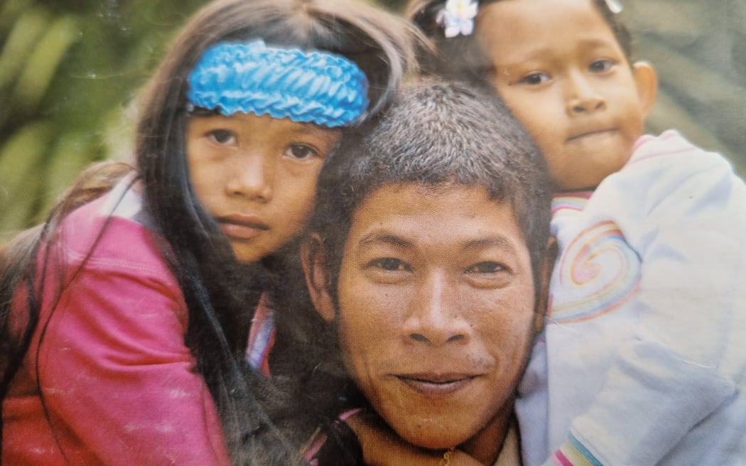 Faisal in an old photograph with his two girls shortly after they arrived in New Zealand.