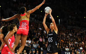 Silver Ferns Ameliaranne Ekenasio shoots for goal against the England defense.