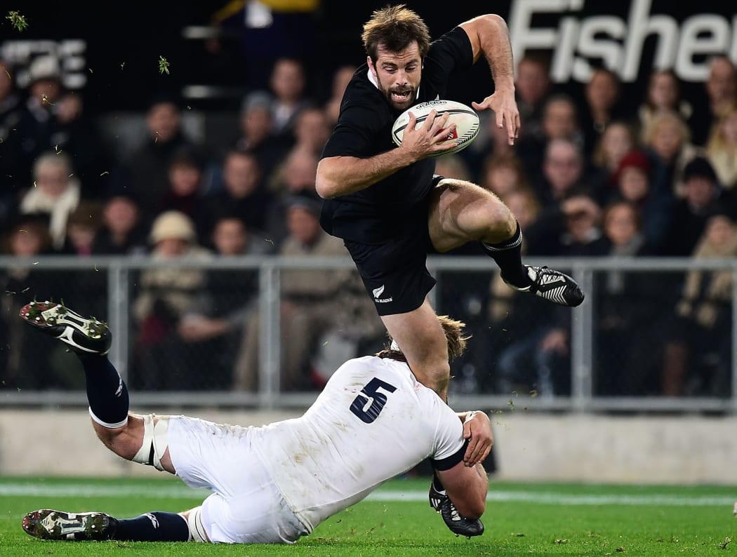 All Black Conrad Smith is tackled by England's Geoff Parling during the second  test match in Dunedin on June 14.