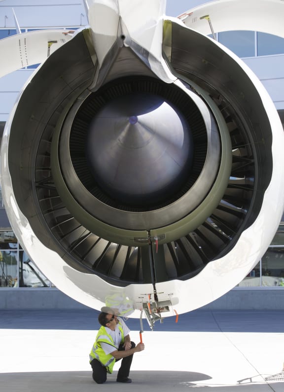 A crew member works on the Rolls Royce engine of an Air New Zealand Boeing 787-9 Dreamliner in 2014.