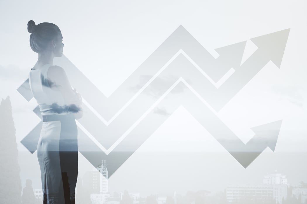 Businesswoman with chart arrows on wall. Financial growth concept