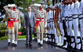 In this handout photograph taken and released by the Pakistan's Press Information Department (PID) on August 14, 2023, Pakistan's newly appointed caretaker Prime Minister, Anwaar-ul-Haq Kakar (2L) is presented with guard of honor at the Prime Minister House in Islamabad. Little-known senator Anwaar-ul-Haq Kakar was sworn-in on August 14 as Pakistan's caretaker Prime Minister to see the country through to an election due in months. Kakar, 52, takes charge of a country that has been wracked by political and economic instability for months, with Imran Khan -- Pakistan's most popular politician -- in jail and disqualified from elections for five years. (Photo by PAKISTAN PRESS INFORMATION DEPARTMENT / AFP) / XGTY / RESTRICTED TO EDITORIAL USE - MANDATORY CREDIT "AFP PHOTO/Pakistan's Press Information Department (PID)" - NO MARKETING NO ADVERTISING CAMPAIGNS - DISTRIBUTED AS A SERVICE TO...