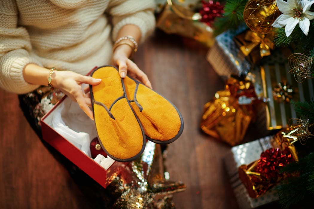 Christmas tree near present boxes, slippers.
