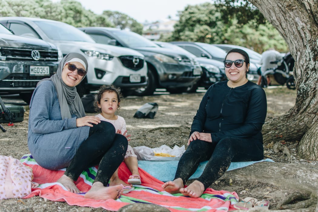 Aliya, Lara and Fatima eating fish and chips on Milford Beach.