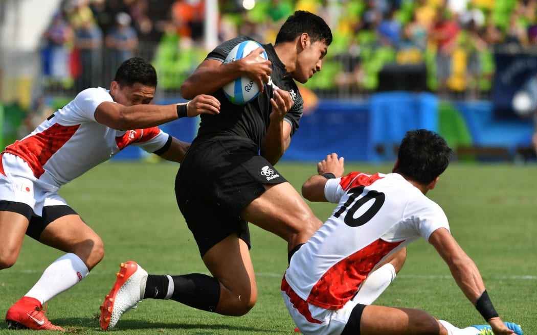 Akira Ioane is tackled in the men’s rugby sevens match against Japan.