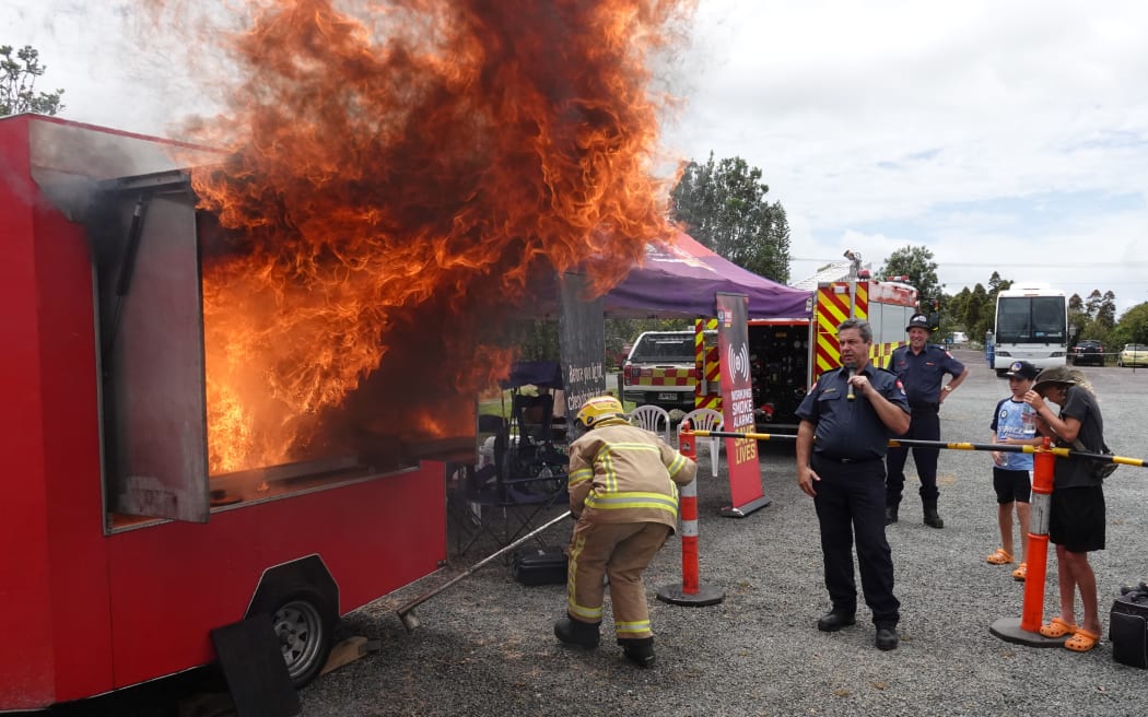 Volunteers from Kaikohe Fire Brigade show how not to put out a burning pot of oil.