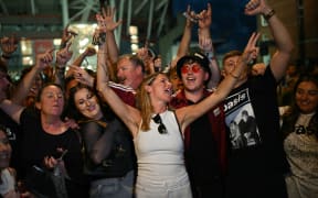 Fans of British rock band Oasis react outside the Principality Stadium in Cardiff on July 4, 2025, after attending the opening concert of their highly anticipated reunion tour nearly 16 years after last performing together. Two consecutive nights of concerts at the Principality Stadium in the Welsh capital mark the start of a 41-date run of gigs spanning the world. (Photo by Oli SCARFF / AFP)
