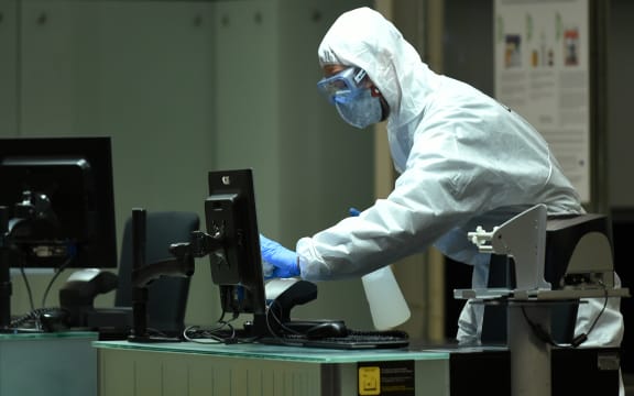 A members of the military emergencies unit (UME) carrying out a disinfection at an airport in Barcelona, 19 March.