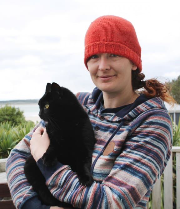 Cat-lover Nico Jarvis, of Omaui, holding her neighbour’s 8-year-old cat, Nhabuz Fishaw.