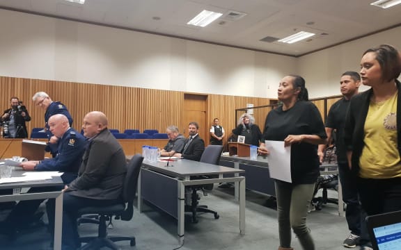 Ani Nohinohi and her supporters approach the witness stand.