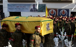 Hezbollah militants carry the coffin of slain Hezbollah military commander Wissam Tawil (Jawad) during his funeral in his hometown village of Khirbet Selm, south of Beirut on January 9, 2024. Hezbollah announced on January 8 the killing of a "commander" for the first time, naming him as Wissam Hassan Tawil. A security souce in Lebanon, requesting anonymity for security reasons, said Tawil "had a leading role in managing Hezbollah's operations in the south", and was killed there by an Israeli strike targeting his car. (Photo by MAHMOUD ZAYYAT / AFP)