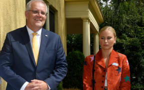 Grace Tame appears visibly uncomfortable as she stands for a picture with Scott Morrison