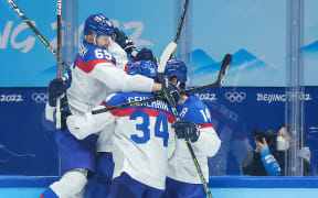 Athletes of Slovakia celebrate scoring during the ice hockey men's quarterfinal of Beijing 2022 Winter Olympics against the United States.