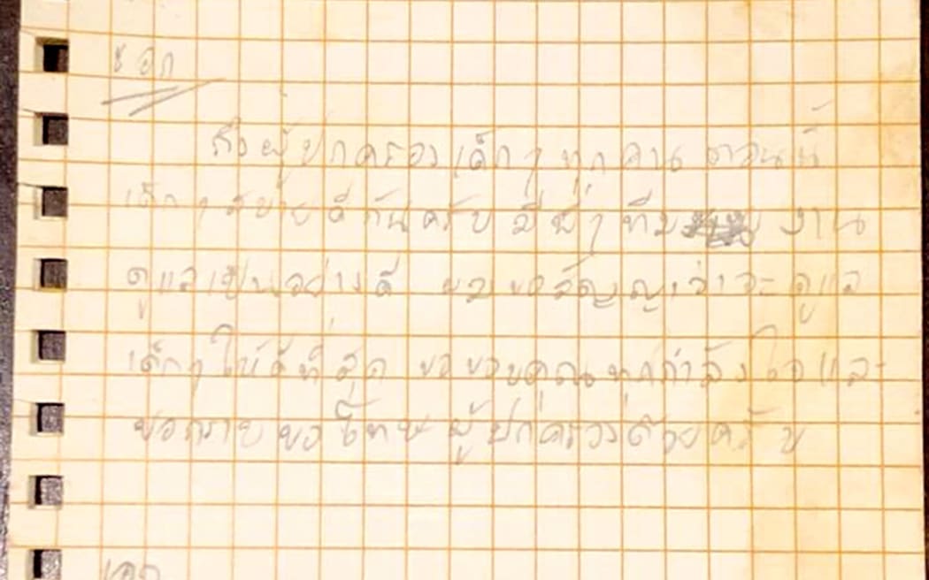 This photo released by the Royal Thai Navy SEAL shows a letter written by the 25-year-old football coach Ekkapol Chantawong and handed to a diver on July 6 apologising to the boys' parents and thanking everyone for their moral support.