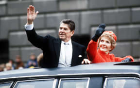 40th U.S. President Ronald REAGAN 1911-2004 and First Lady Nancy Reagan wave to the crowd waiting along the Inaugural parade route down Pennsylvania Avenue, Washington DC, 20 January 1981