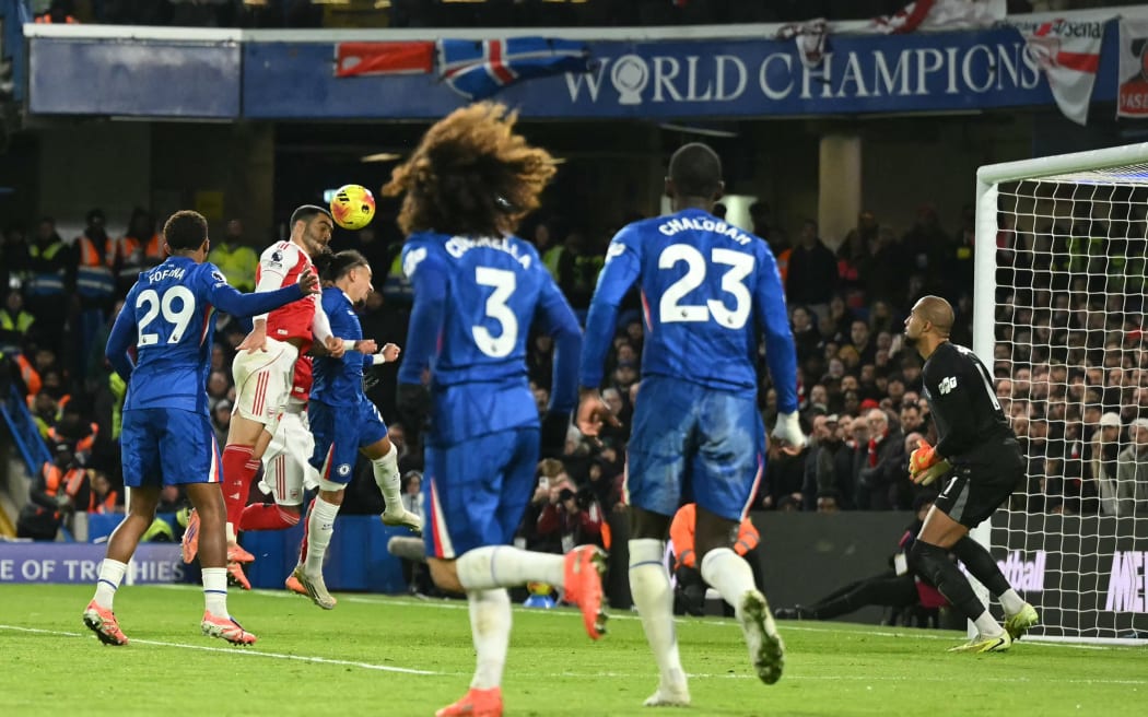 Arsenal's Spanish midfielder Mikel Merino heads home against Chelsea, 2025.