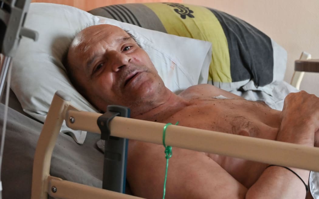 (FILES) In this file photo taken on August 12, 2020 Alain Cocq, suffering from an orphan desease of the blood, rests on his medical bed in his flat in Dijon, northeastern France.