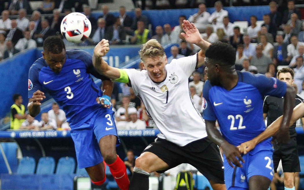 Germany's Bastian Schweinsteiger gives away a penalty as he challenges Patrice Evra.