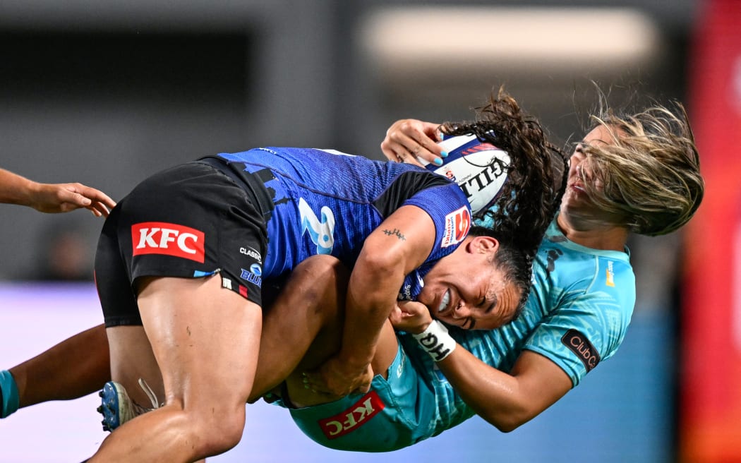 Portia Woodman-Wickliffe of the Blues makes a hard tackle on Kaea Nepia of Matatū, nib Blues Women v Matatu, Super Rugby Aupiki Grand Final.
