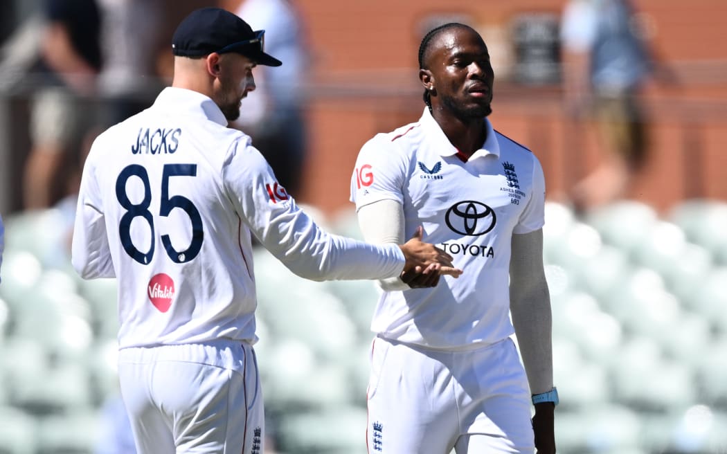 Jofra Archer of England (right) celebrates taking a wicket.