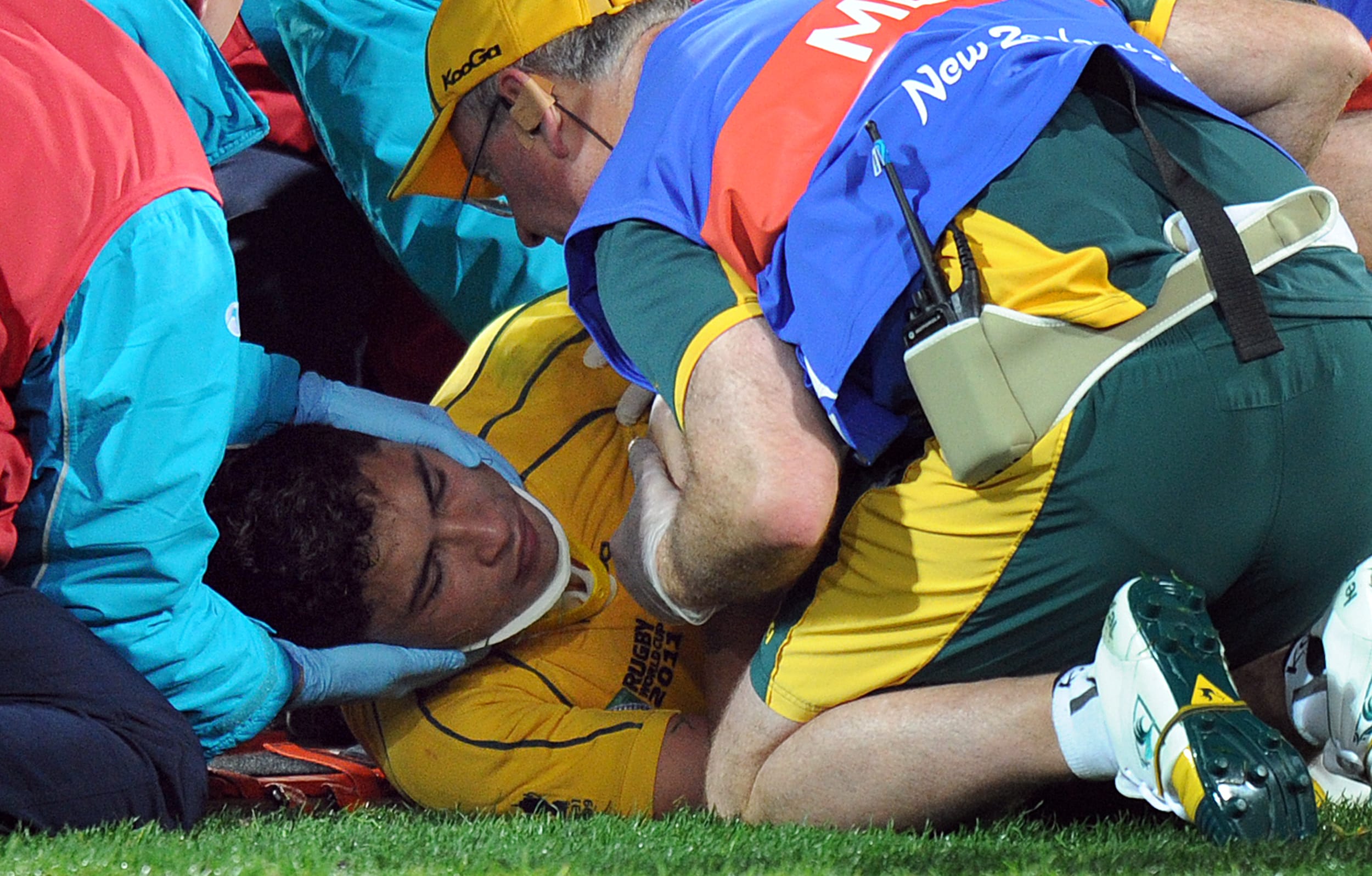Wallabies player Anthony Faingaa is rolled onto a stretcher after receiving an accidental knee to the head during the 2011 Rugby World Cup.