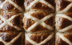 A section of fresh made hot cross buns.