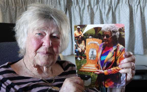 Cherry Daly with a photo of her mother Gwen Daly and the Mick Griffin Memorial Trophy, named in honour of her axeman grandfather.